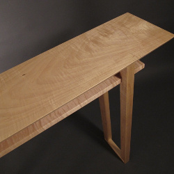 A beautiful light blonde colored wood, the tiger maple seems to shimmer in the light. Seen here on our Classic Console Table a narrow wood table, modern wood table